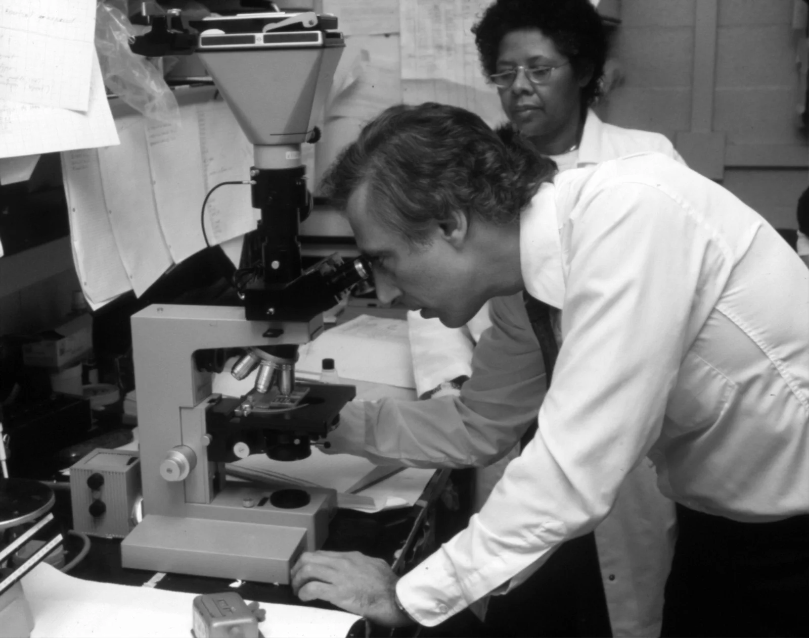 Researcher working with a microscope